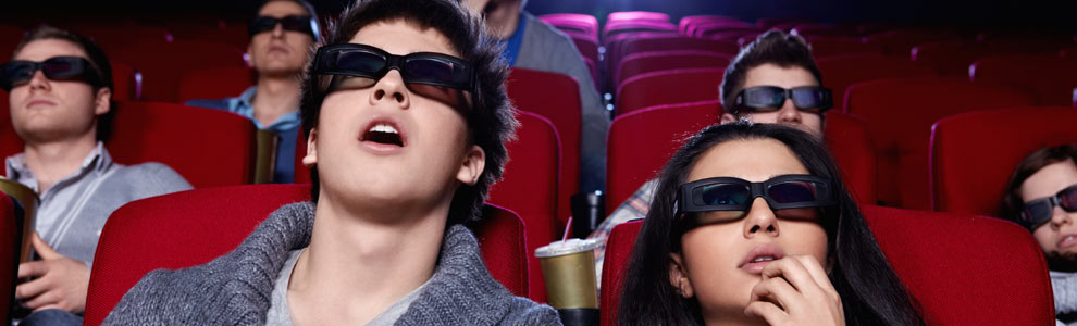 A couple, mouths agape, watching a 3-D movie